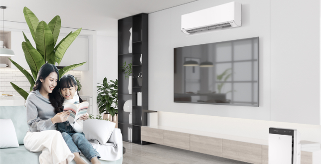 Mother and daughter reading book in living room featuring Panasonic air conditioner and air purifier