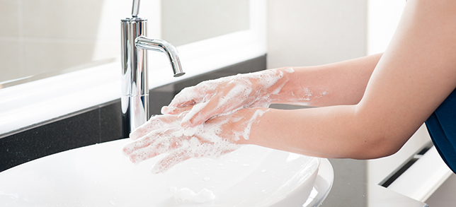 A woman washing her hands with soap